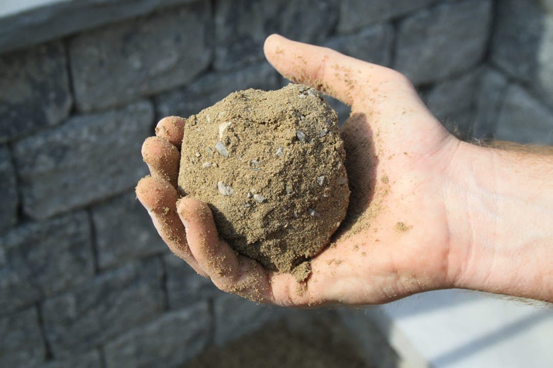 Snowball test shows the correct amount of moisture needed when installing the Endicott Pathway Aggregate, mixed with organic-lock